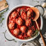 tofubällchen Tofubällchen in Tomatensauce in Topf mit Kochlöffel